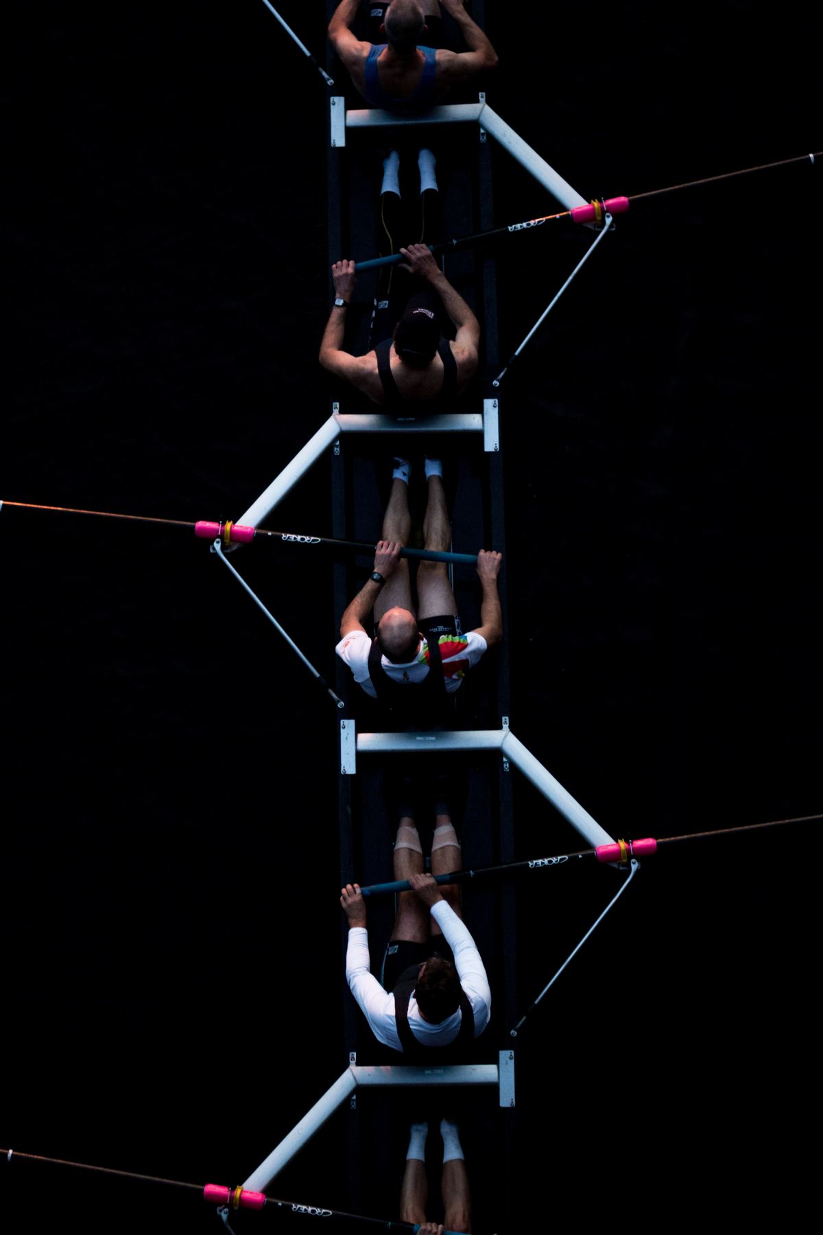 A rowing eight seen from above, oars moving in unison